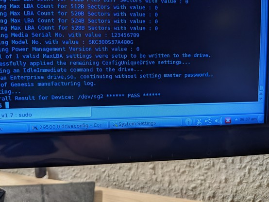 A more close-up shot of a terminal window on the computer monitor. Among a lot of text the word "PASS" can be seen, surrounded by asterisks.