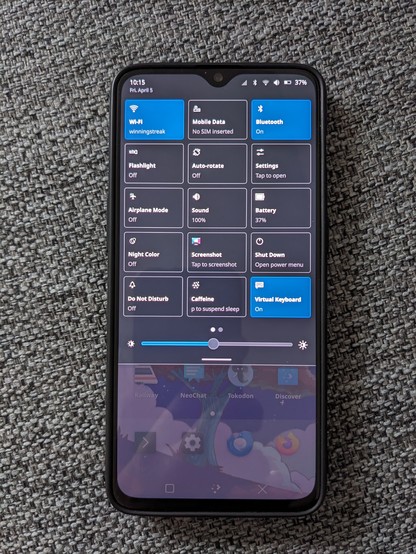 Photo of a OnePlus 6T running KDE Plasma Mobile 6.0.3 showing the quick settings pulldown.