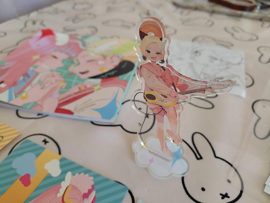 Close up of the acrylic stand featuring a character playing an electric guitar.