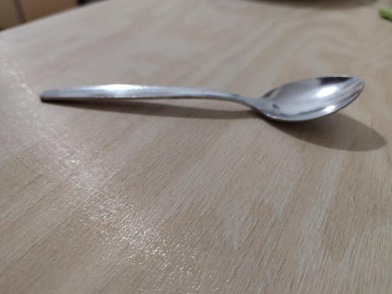 Close up photo of the counter surface with a teaspoon for scale.